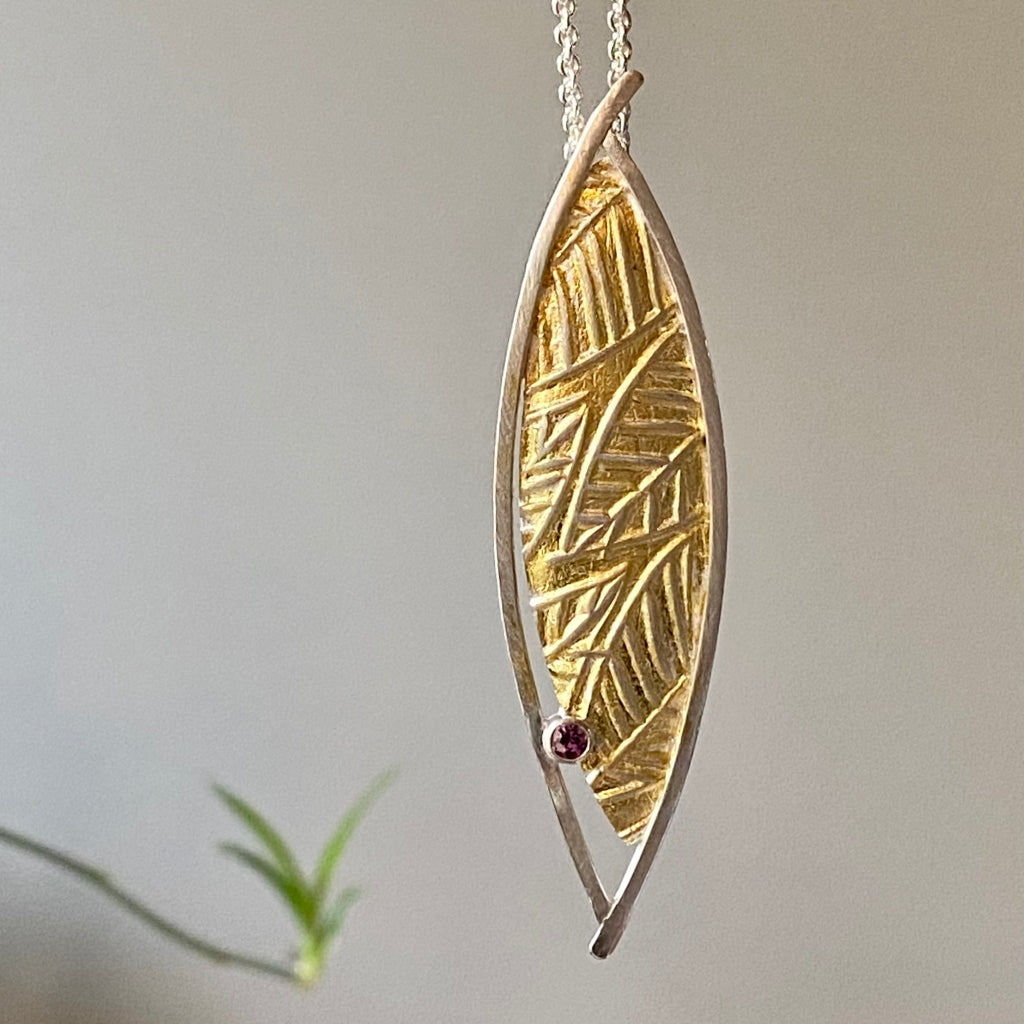 Flow pendant. Argentium silver, 24-karat gold, rhodolite garnet on an 18-inch silver chain.