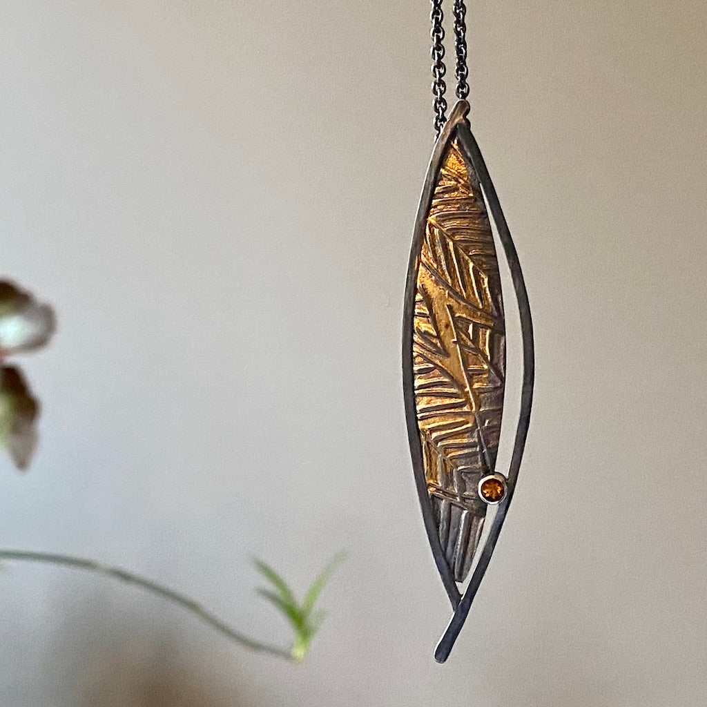 Flow pendant, Oxidized Argentium and fine silver, 24-karat gold, citrine on an 18-inch silver chain.