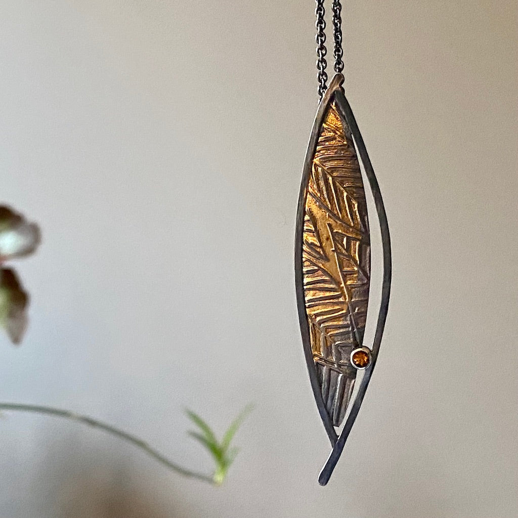 Flow pendant, Oxidized Argentium and fine silver, 24-karat gold, citrine on an 18-inch silver chain.